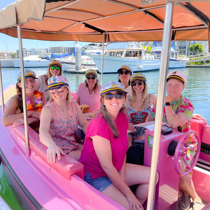 a group of people on a boat posing for the camera