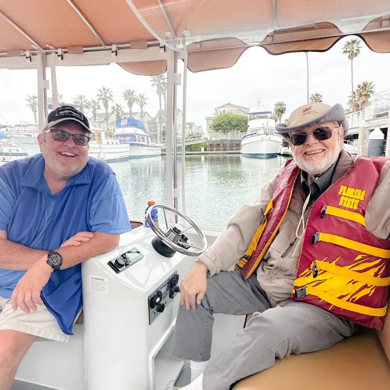 a man and a woman sitting on a boat