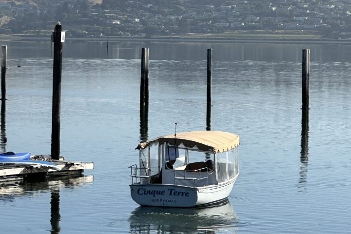 a boat is docked next to a body of water