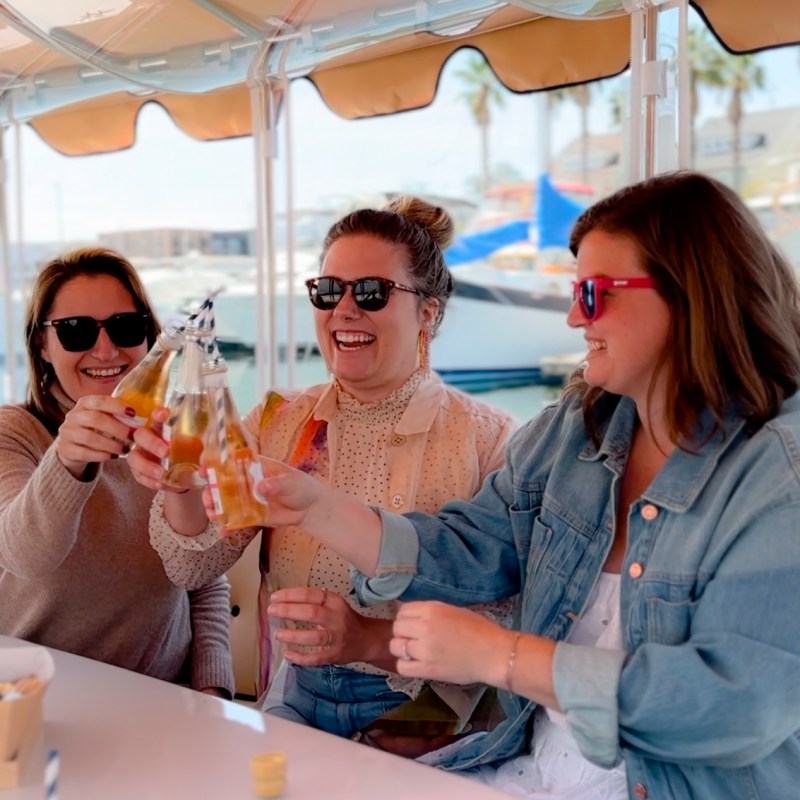 a group of people sitting at a table with wine glasses